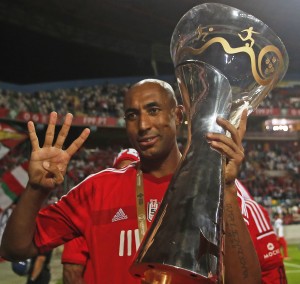 Benfica's Luisao celebrates with trophy after defeating Rio Ave in the Portuguese Super Cup at Aveiro's city stadium